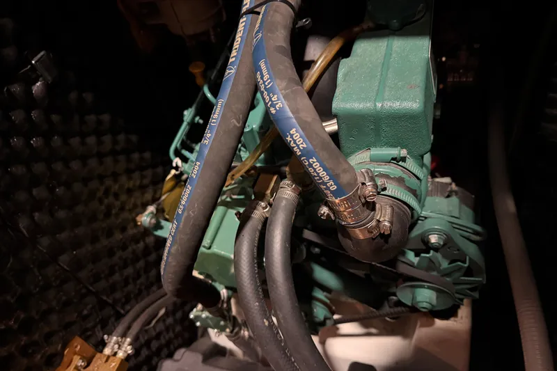 Slide: The Image of Engine compartment of a 2006 Beneteau First 36.7 sailboat, featuring hoses and mechanical components. - 88