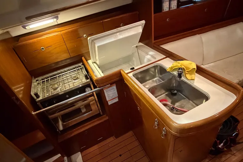 Slide: The Image of Galley of 2006 Beneteau First 36.7 with stove, sink, and storage cabinets. - 92