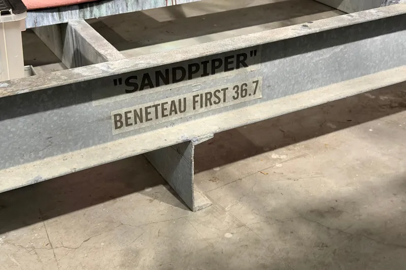 Slide: The Image of Beneteau First 36.7 sailboat trailer labeled "Sandpiper," 2006 model, in storage. - 95