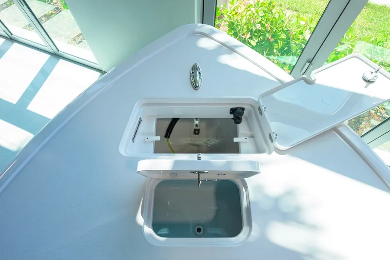 Slide: The Image of 2026 Sportsman Masters 247OE Bay Boat with open storage compartments, showcasing sleek design. - 13