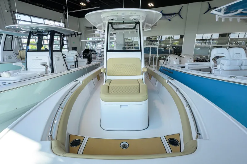 Slide: The Image of 2026 Sportsman Masters 247OE Bay Boat interior with seating in showroom. - 15
