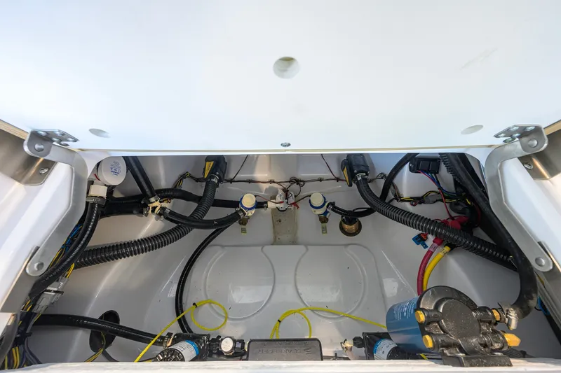 Slide: The Image of 2026 Sportsman Masters 247OE Bay Boat wiring and plumbing compartment view. - 40