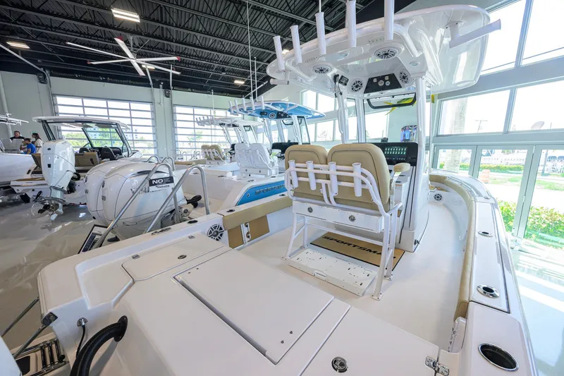 Slide: The Image of 2026 Sportsman Masters 247OE Bay Boat in showroom, featuring modern design and equipment. - 19