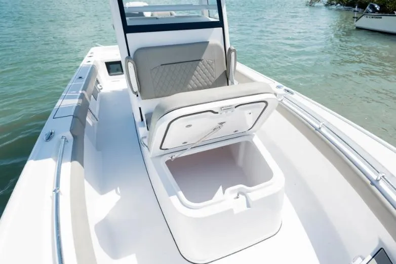 Slide: The Image of 2026 Sportsman Masters 247OE Bay Boat with open storage compartment on deck. - 2