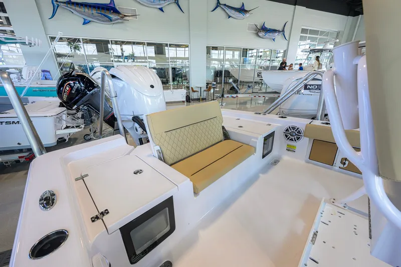 Slide: The Image of 2026 Sportsman Masters 247OE Bay Boat interior with seating and modern features in showroom. - 31