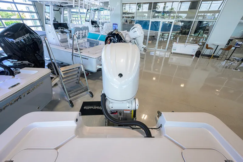 Slide: The Image of 2026 Sportsman Masters 247OE Bay Boat in showroom, featuring powerful outboard motor. - 37