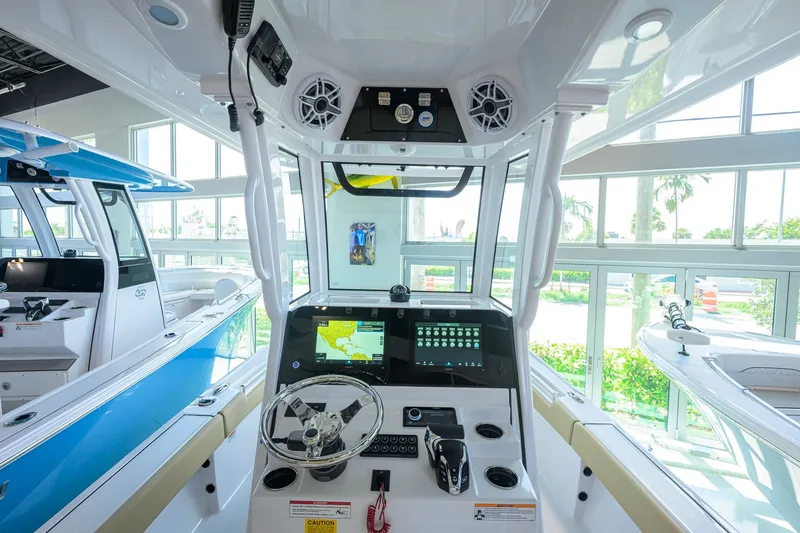 Slide: The Image of 2026 Sportsman Masters 247OE Bay Boat interior with advanced navigation system and steering console. - 7