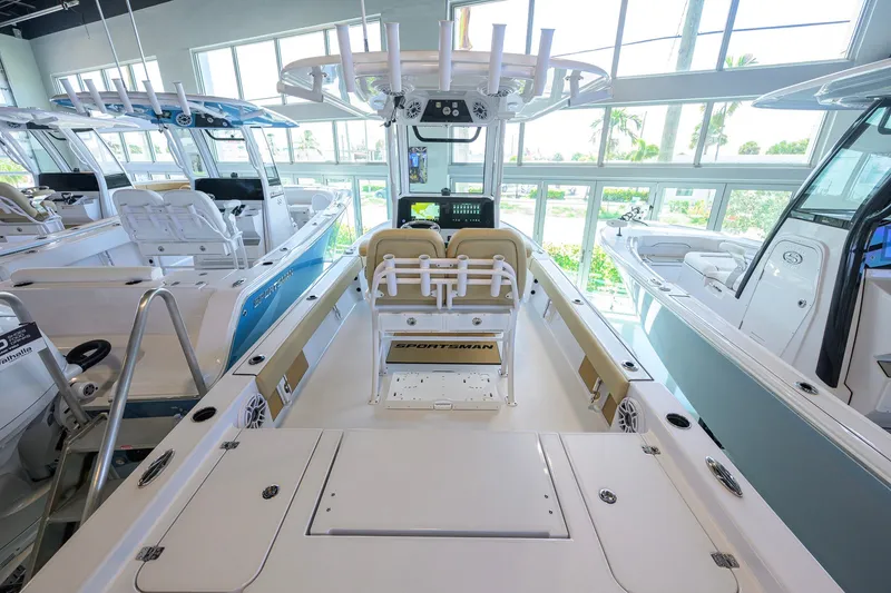 Slide: The Image of 2026 Sportsman Masters 247OE Bay Boat interior, showcasing seating and helm in a showroom. - 24