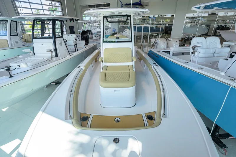 Slide: The Image of 2026 Sportsman Masters 247OE Bay Boat displayed in a showroom, featuring sleek design and seating. - 14