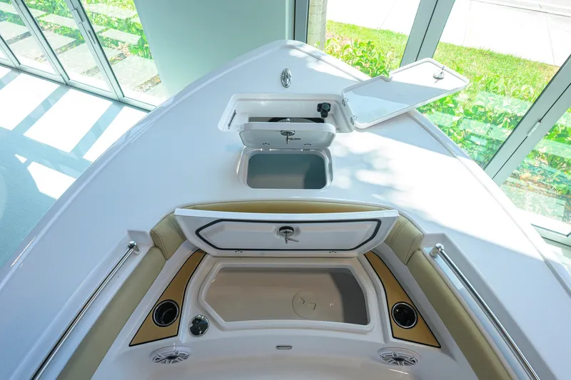 Slide: The Image of 2026 Sportsman Masters 247OE Bay Boat interior with open storage compartments and seating. - 12