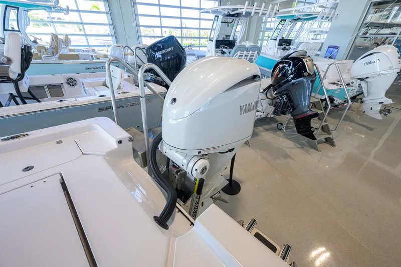 Slide: The Image of 2026 Sportsman Masters 247OE Bay Boat with Yamaha outboard engine in showroom. - 36