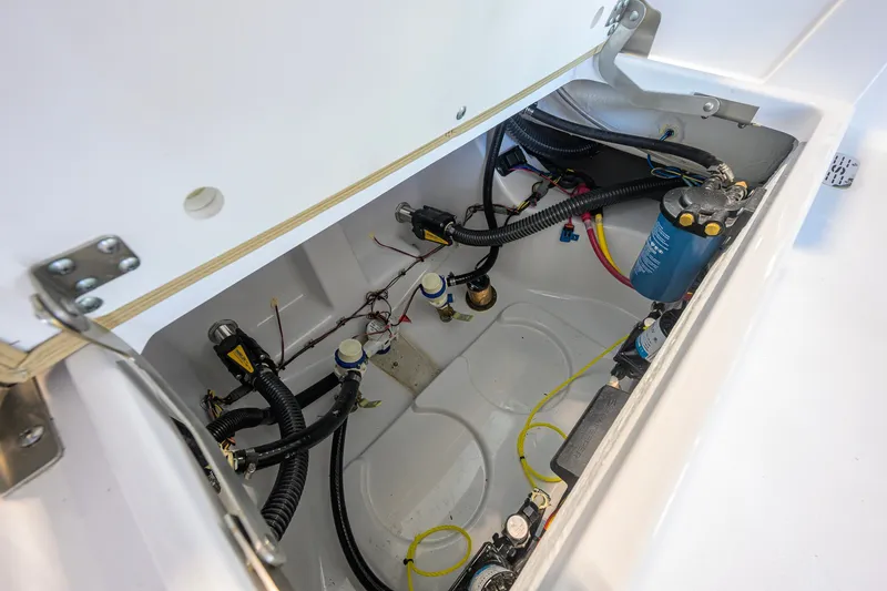 Slide: The Image of Interior view of 2026 Sportsman Masters 247OE Bay Boat's wiring and plumbing system. - 39