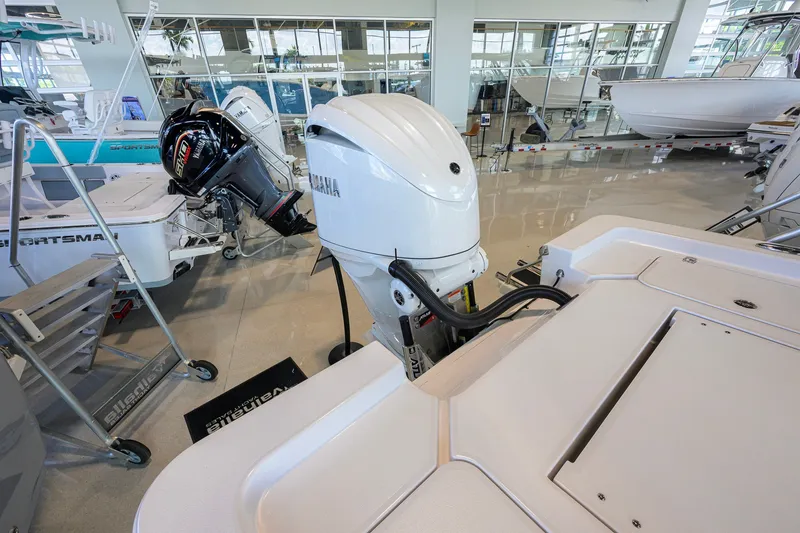 Slide: The Image of 2026 Sportsman Masters 247OE Bay Boat in showroom, featuring powerful outboard motor. - 38