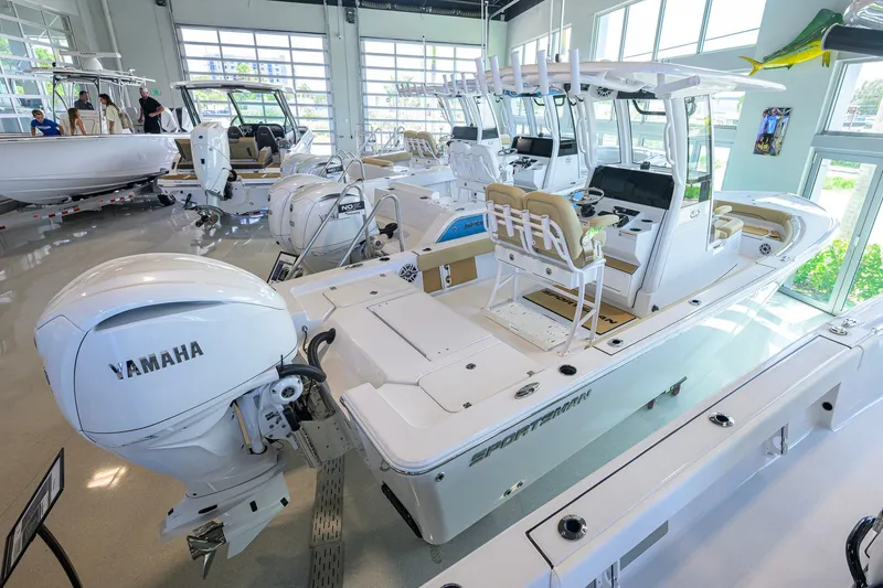 Slide: The Image of 2026 Sportsman Masters 247OE Bay Boat in showroom with Yamaha engine. - 4