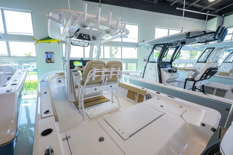 Slide: The Image of 2026 Sportsman Masters 247OE Bay Boat interior in showroom, featuring modern seating and controls. - 25