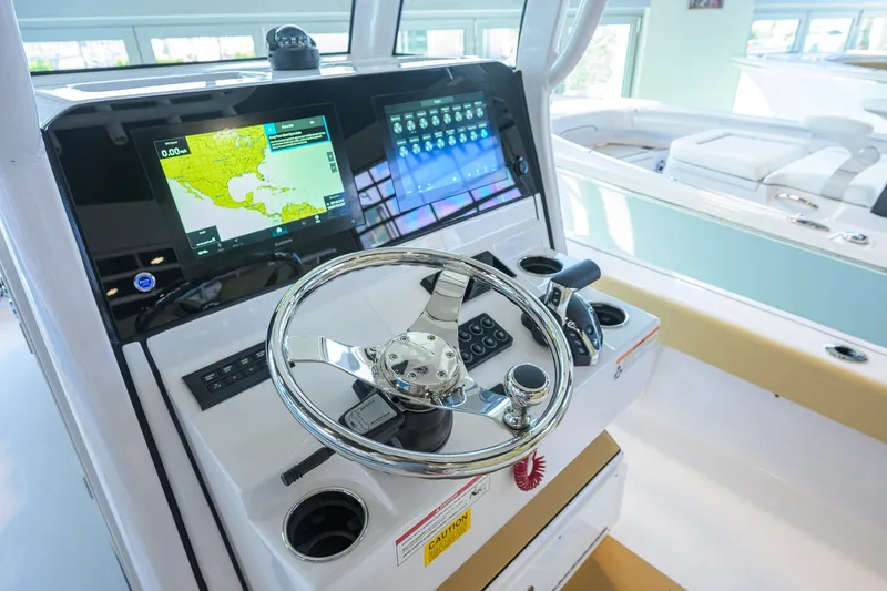 Slide: The Image of 2026 Sportsman Masters 247OE Bay Boat helm with advanced navigation displays and controls. - 8