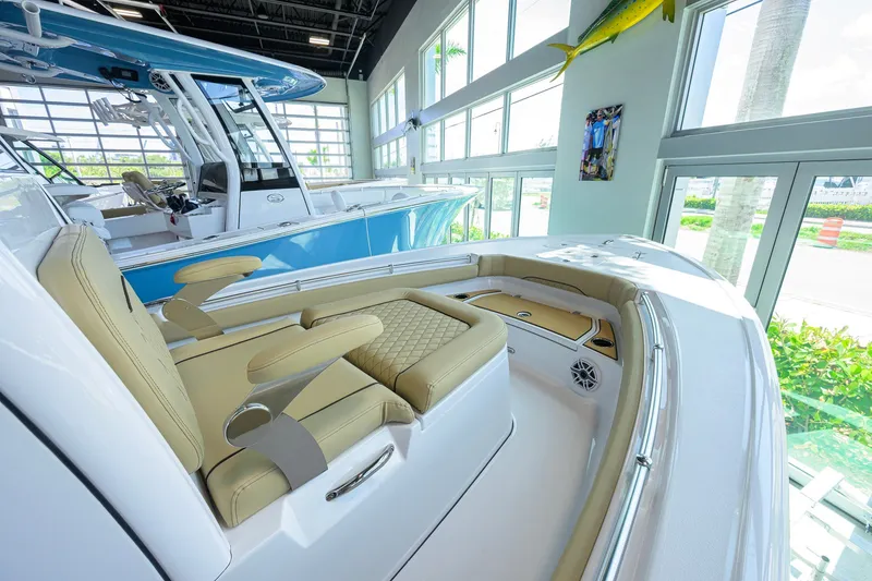 Slide: The Image of 2026 Sportsman Masters 247OE Bay Boat interior with luxurious seating in showroom. - 18