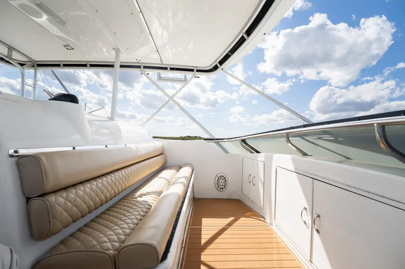 Slide: The Image of Luxurious seating area on 1995 Hatteras 50 Convertible yacht under a clear blue sky. - 14
