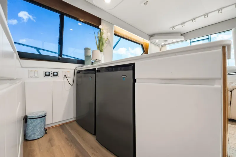 Slide: The Image of Interior of 1995 Hatteras 50 Convertible yacht kitchen with modern appliances and large windows. - 19