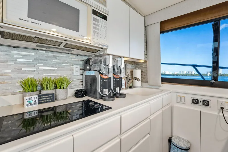 Slide: The Image of Modern kitchen interior of 1995 Hatteras 50 Convertible yacht with ocean view. - 21