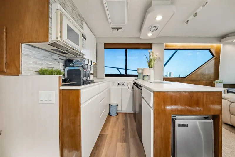 Slide: The Image of Luxurious kitchen interior of 1995 Hatteras 50 Convertible yacht with modern appliances. - 22