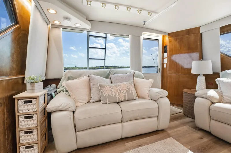 Slide: The Image of Luxurious interior of 1995 Hatteras 50 Convertible yacht with plush seating and scenic view. - 23