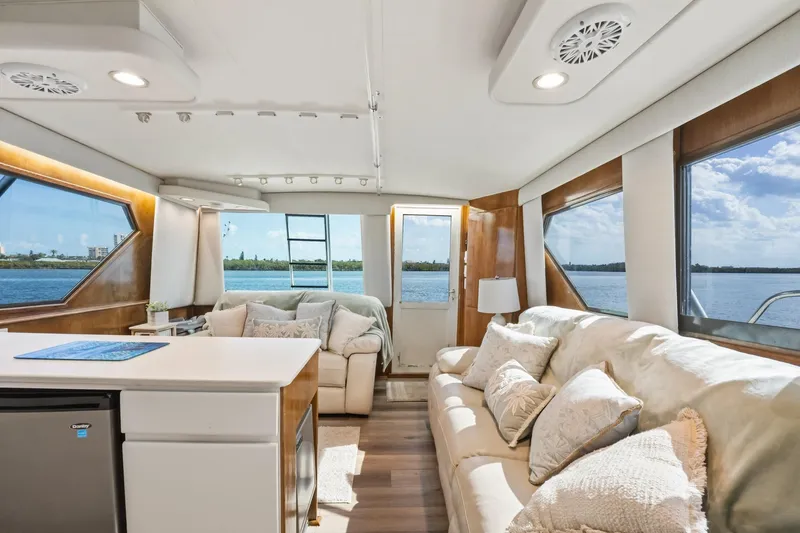 Slide: The Image of Luxurious interior of 1995 Hatteras 50 Convertible yacht with scenic water views. - 24