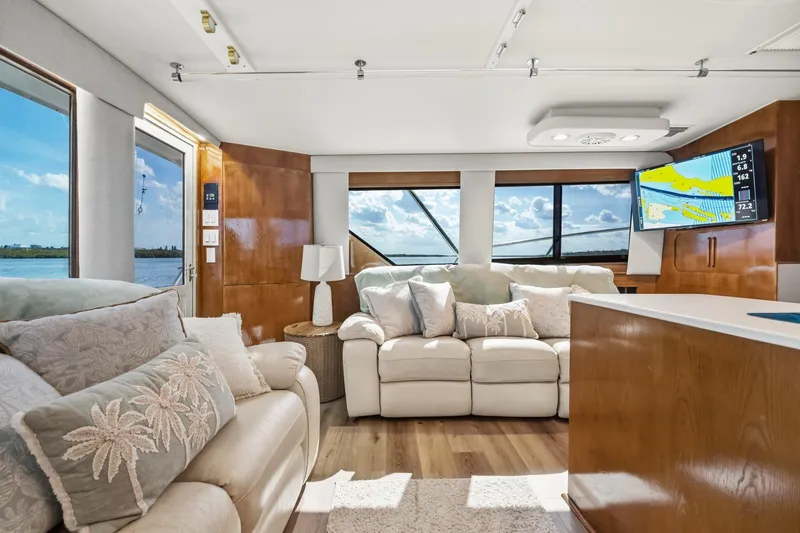 Slide: The Image of Luxurious interior of 1995 Hatteras 50 Convertible yacht with plush seating and scenic views. - 25
