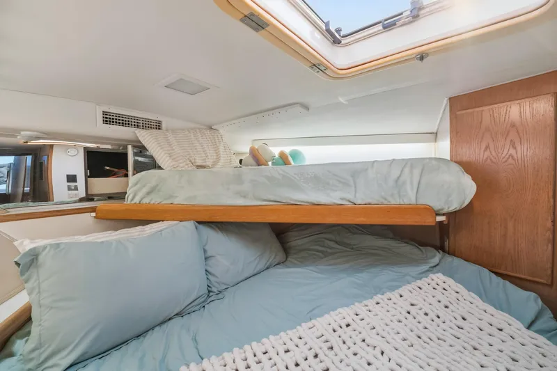 Slide: The Image of Interior cabin of 1995 Hatteras 50 Convertible yacht with cozy bedding and skylight. - 38
