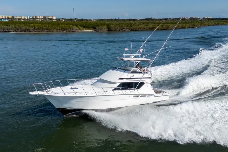 Slide: The Image of 1995 Hatteras 50 Convertible yacht cruising on a sunny day. - 6