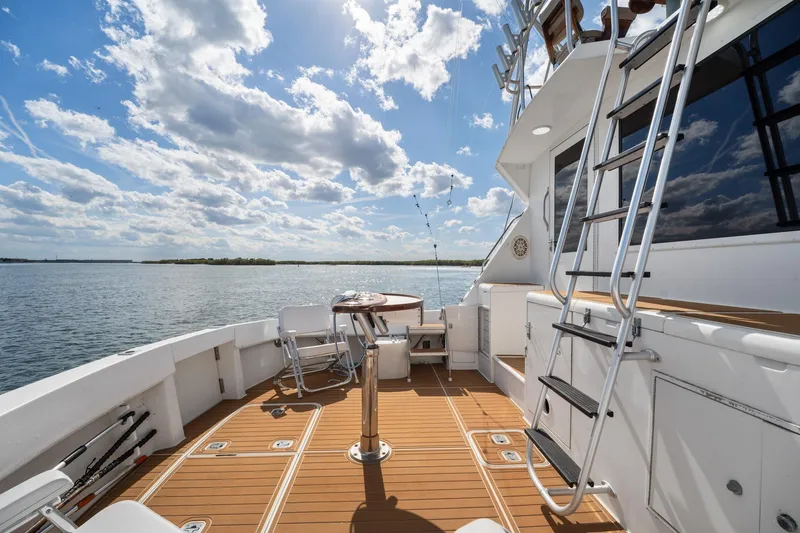 Slide: The Image of Hatteras 50 Convertible 1995 on open water with clear sky. - 9