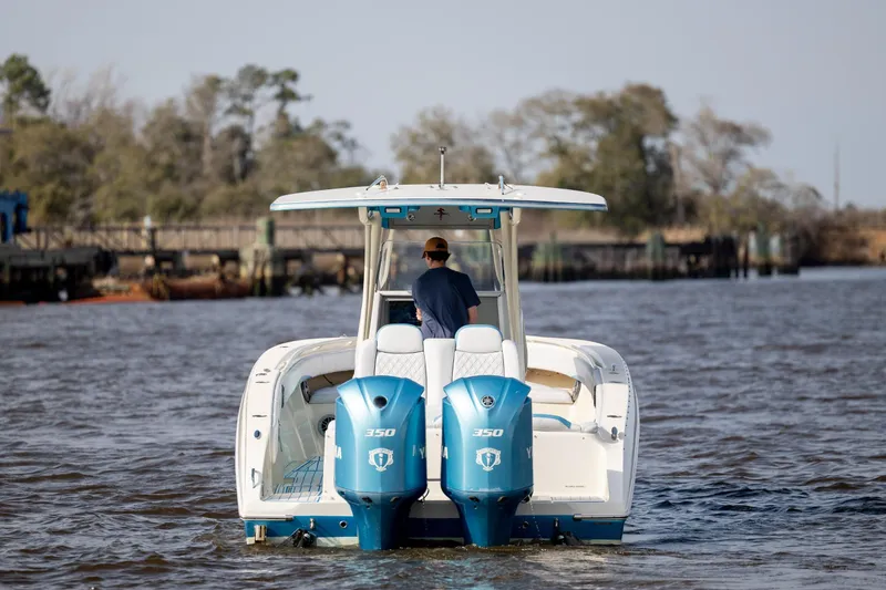 Slide: The Image of 2014 Statement 350 Open boat cruising on a river with dual engines. - 11