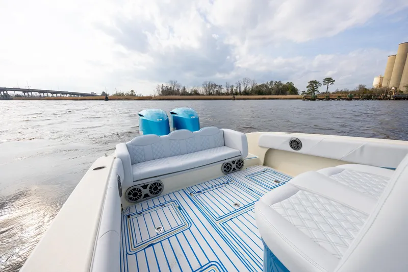 Slide: The Image of 2014 Statement 350 Open boat interior with blue accents on a calm river. - 12