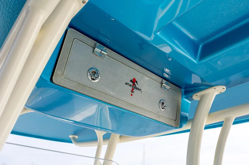 Slide: The Image of 2014 Statement 350 Open boat storage compartment with blue interior and secure latch. - 21