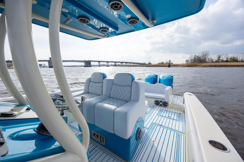 Slide: The Image of 2014 Statement 350 Open boat interior with blue and white seating on a river. - 22