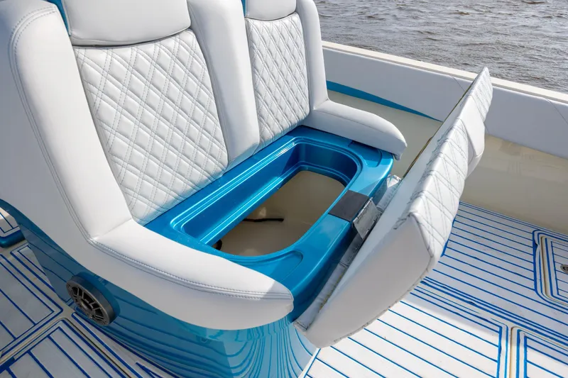 Slide: The Image of 2014 Statement 350 Open boat seat with storage compartment, featuring quilted white upholstery. - 23
