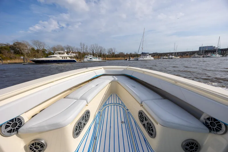 Slide: The Image of 2014 Statement 350 Open boat with cushioned seating, docked near other vessels. - 25