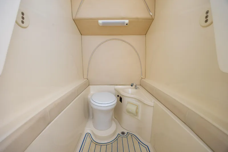 Slide: The Image of 2014 Statement 350 Open boat interior bathroom with toilet and sink. - 29