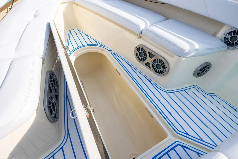 Slide: The Image of 2014 Statement 350 Open boat interior with white seating and blue-striped flooring. - 32