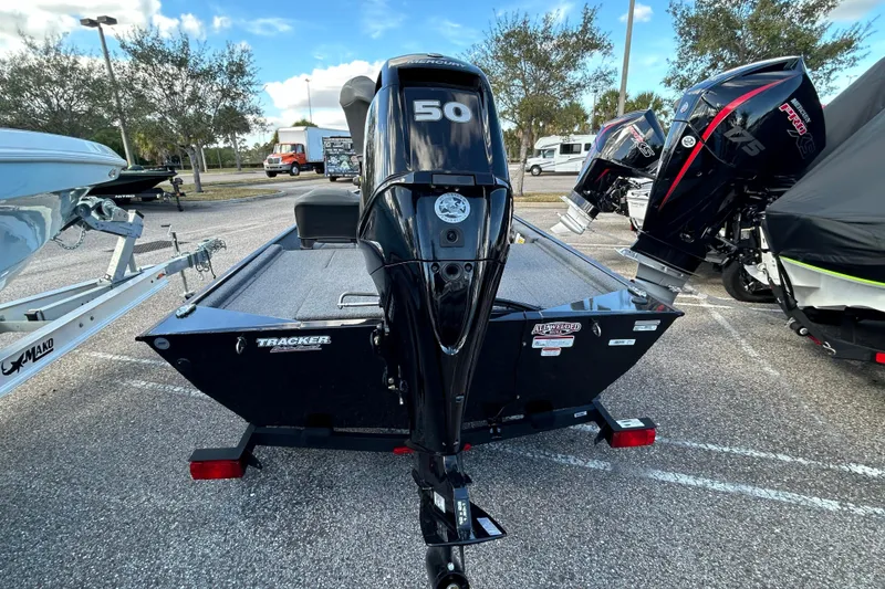 Slide: The Image of 2024 Tracker Bass Tracker Classic XL boat with 50 HP engine in parking lot. - 3