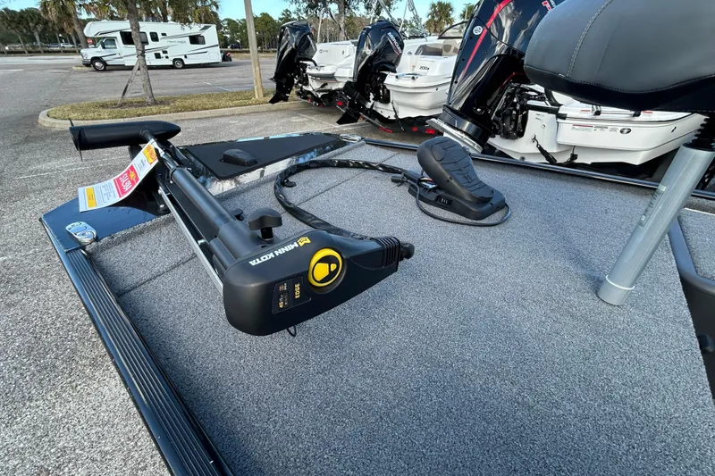 Slide: The Image of 2024 Tracker Bass Tracker Classic XL boat with Minn Kota trolling motor in parking lot. - 5