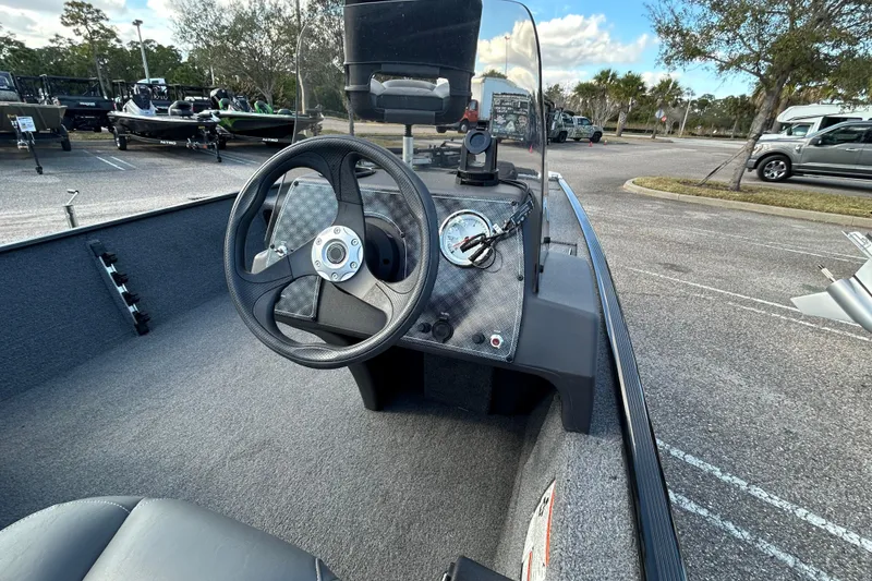 Slide: The Image of 2024 Tracker Bass Tracker Classic XL boat interior with steering wheel and dashboard controls. - 7