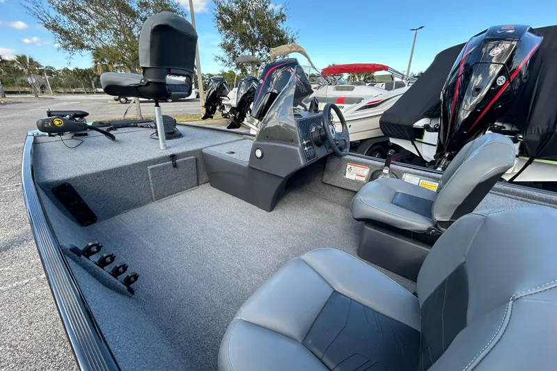 Slide: The Image of 2024 Tracker Bass Tracker Classic XL boat interior with seating and steering console. - 8