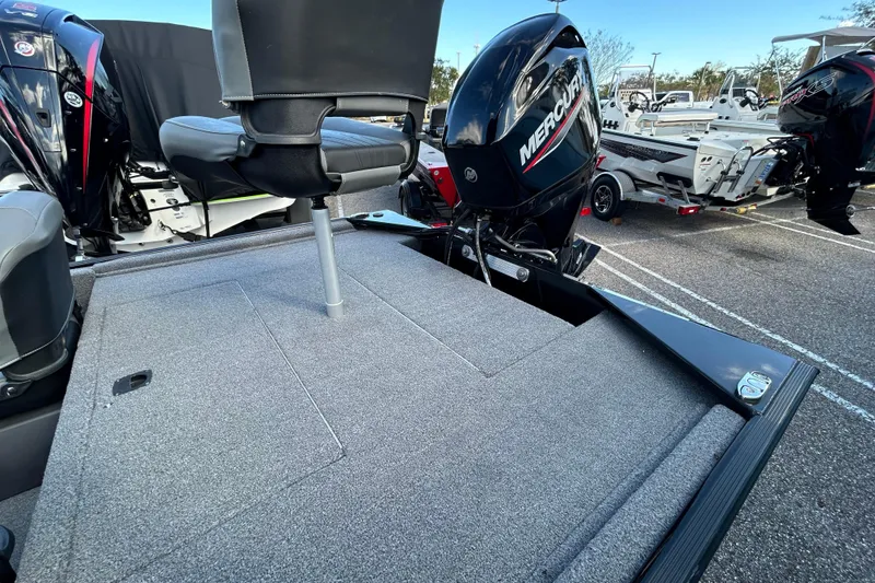 Slide: The Image of 2024 Tracker Bass Tracker Classic XL boat with Mercury engine, featuring a spacious deck and seating. - 9