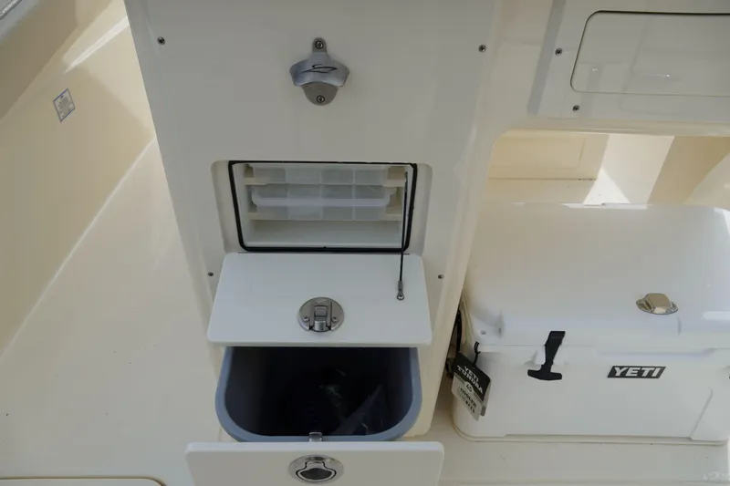 Slide: The Image of 2026 Scout 288 LXF boat interior with storage compartments and Yeti cooler. - 13