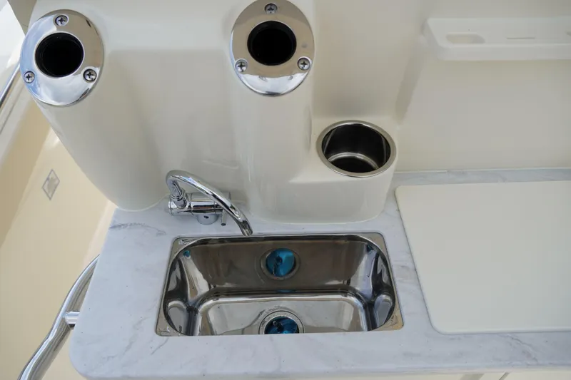 Slide: The Image of 2026 Scout 288 LXF boat sink with faucet and cup holders. - 14