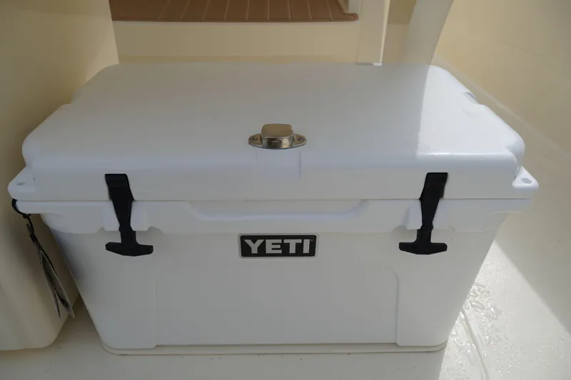Slide: The Image of YETI cooler on 2026 Scout 288 LXF boat deck, featuring secure latches. - 17