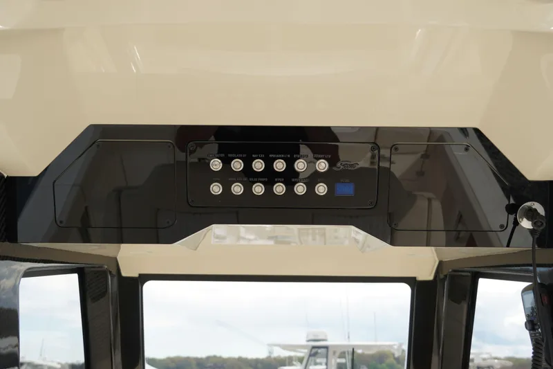 Slide: The Image of Control panel of 2026 Scout 288 LXF boat, featuring various switches and displays. - 20