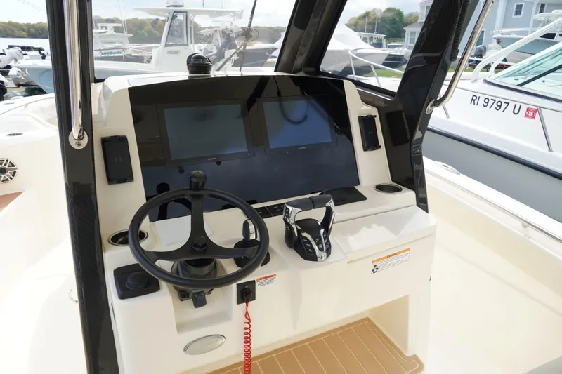 Slide: The Image of Helm of 2026 Scout 288 LXF boat with modern controls and navigation screens. - 21