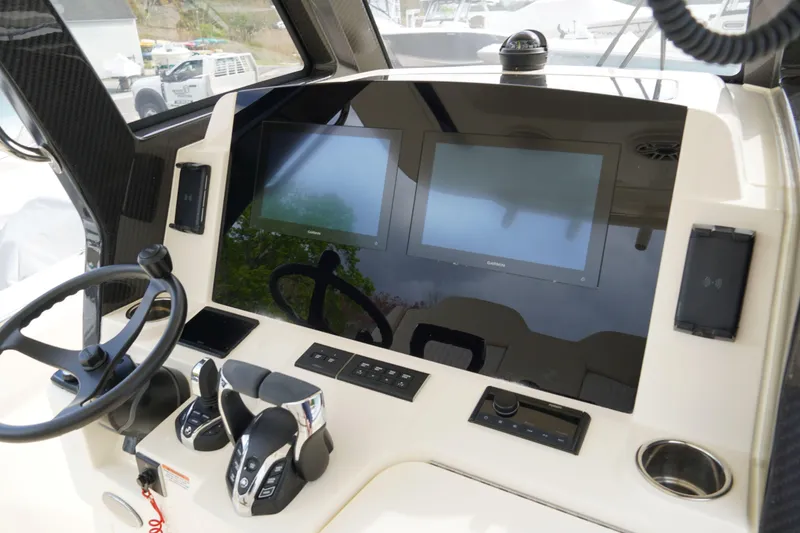 Slide: The Image of Helm of 2026 Scout 288 LXF boat with dual screens and controls. - 22